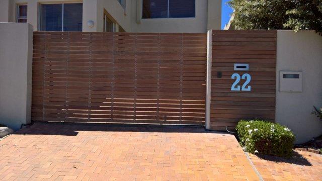 Galvanized Mild Steel Gate Cladded in Balau Wood.
Sterianos Engineering also manufactured and installed the stainless steel letter box cover and house number. 