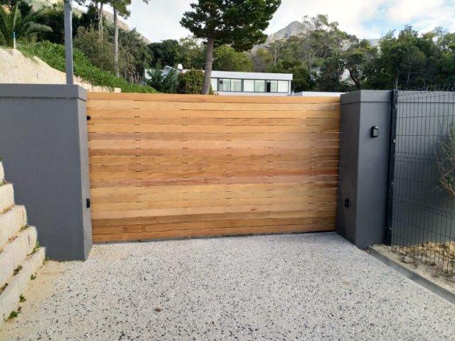 Automated Galvanized Mild Steel Frame Sliding Gate covered with Garapa Wood.